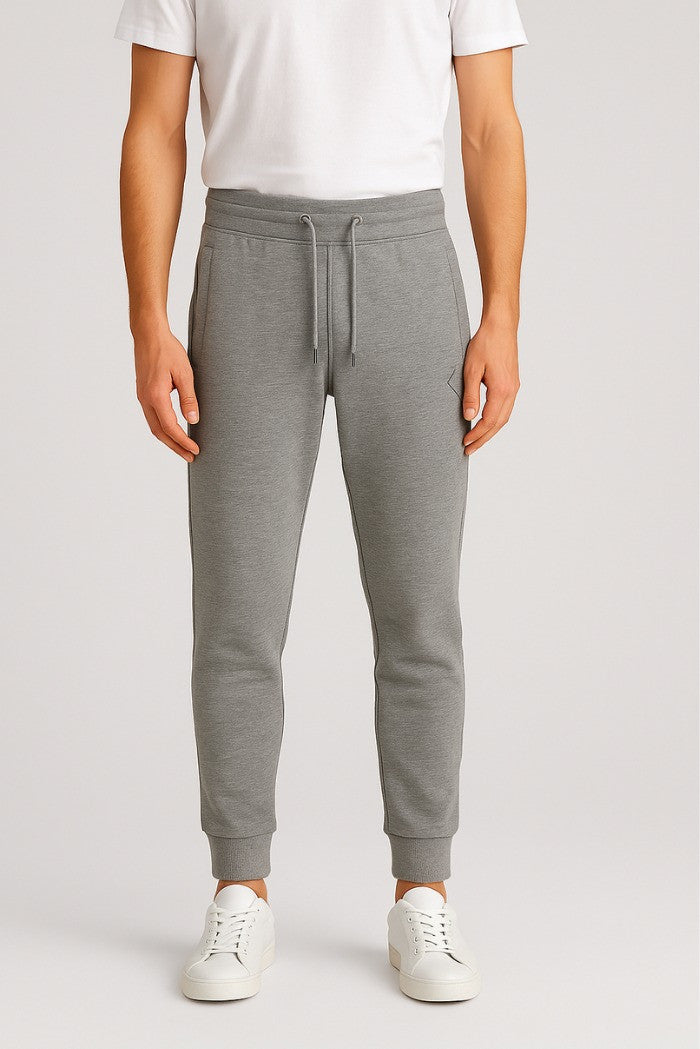 Pantaloni tuta grigio melange con patch gommata e fondo elasticizzato