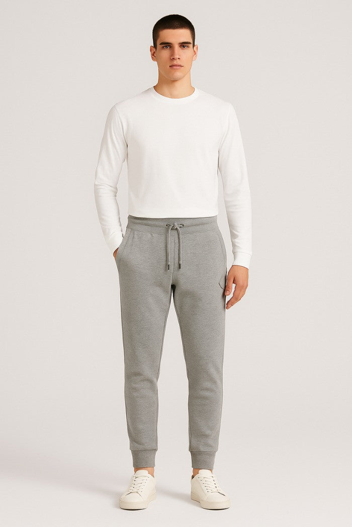 Pantaloni tuta grigio melange con patch gommata e fondo elasticizzato