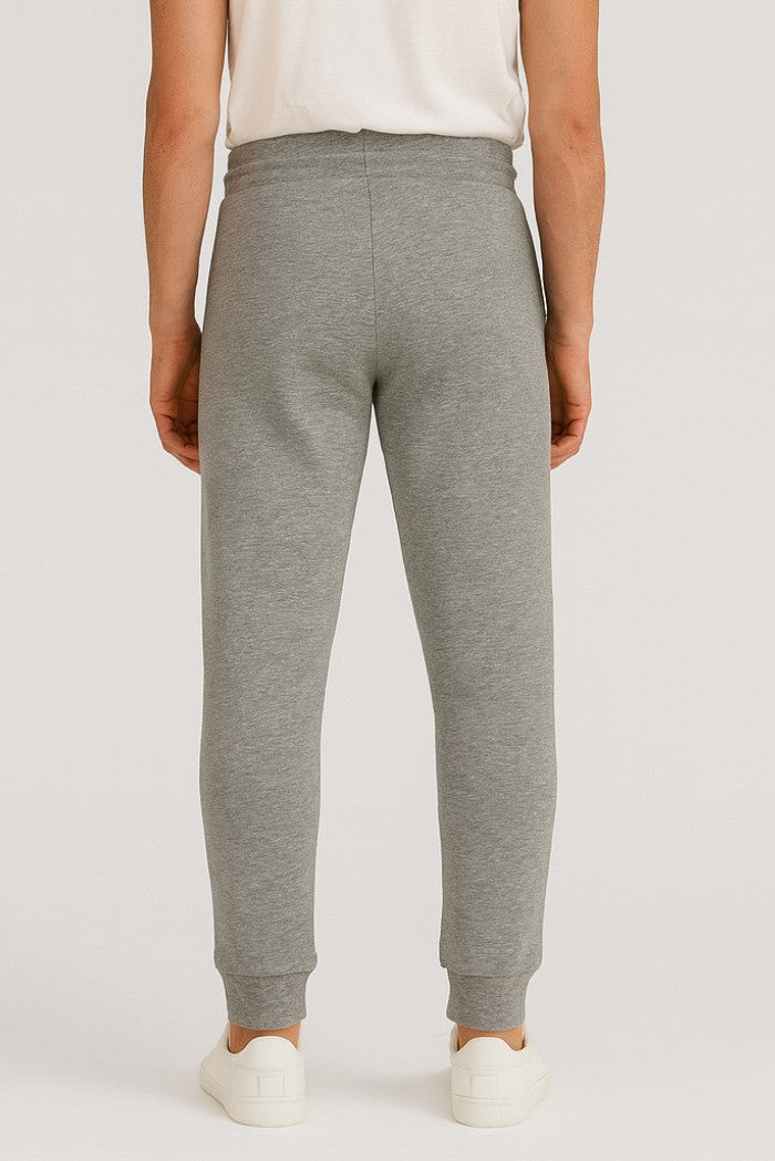 Pantaloni tuta grigio melange con patch gommata e fondo elasticizzato 